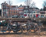Bicycles Parked Beside Brown Wooden Fence Near A River