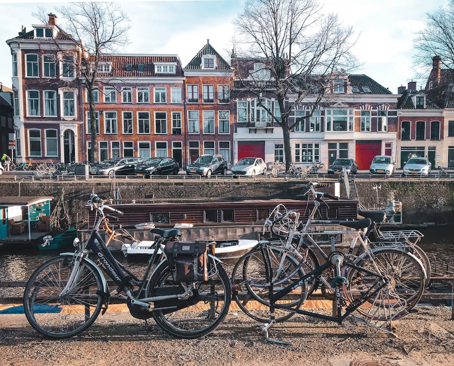 Free Bicycles Parked Beside Brown Wooden Fence Near A River Stock Photo