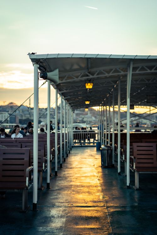 Free Serene ferry ride at sunset with empty seating and scenic views, perfect for travel enthusiasts. Stock Photo