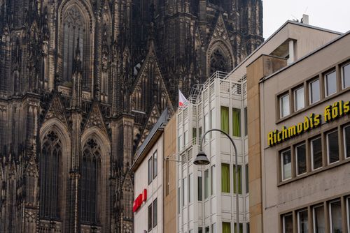 Free View of the iconic Cologne Cathedral alongside modern buildings in Cologne, Germany. Stock Photo