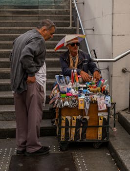 Photo by Melisa Özdemir A street vendor in Istanbul engages with a customer at his colorful stall filled with various items. Urban scene.