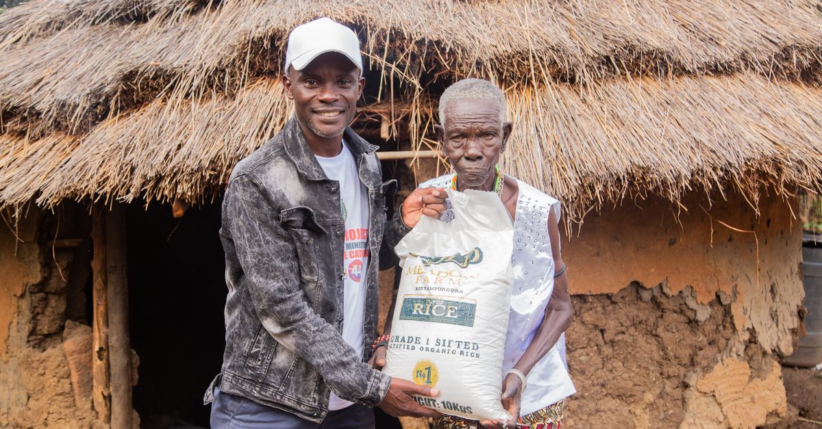 Christ Embassy volunteers distributing food supplies in a rural Volta Region village with smiling community members
