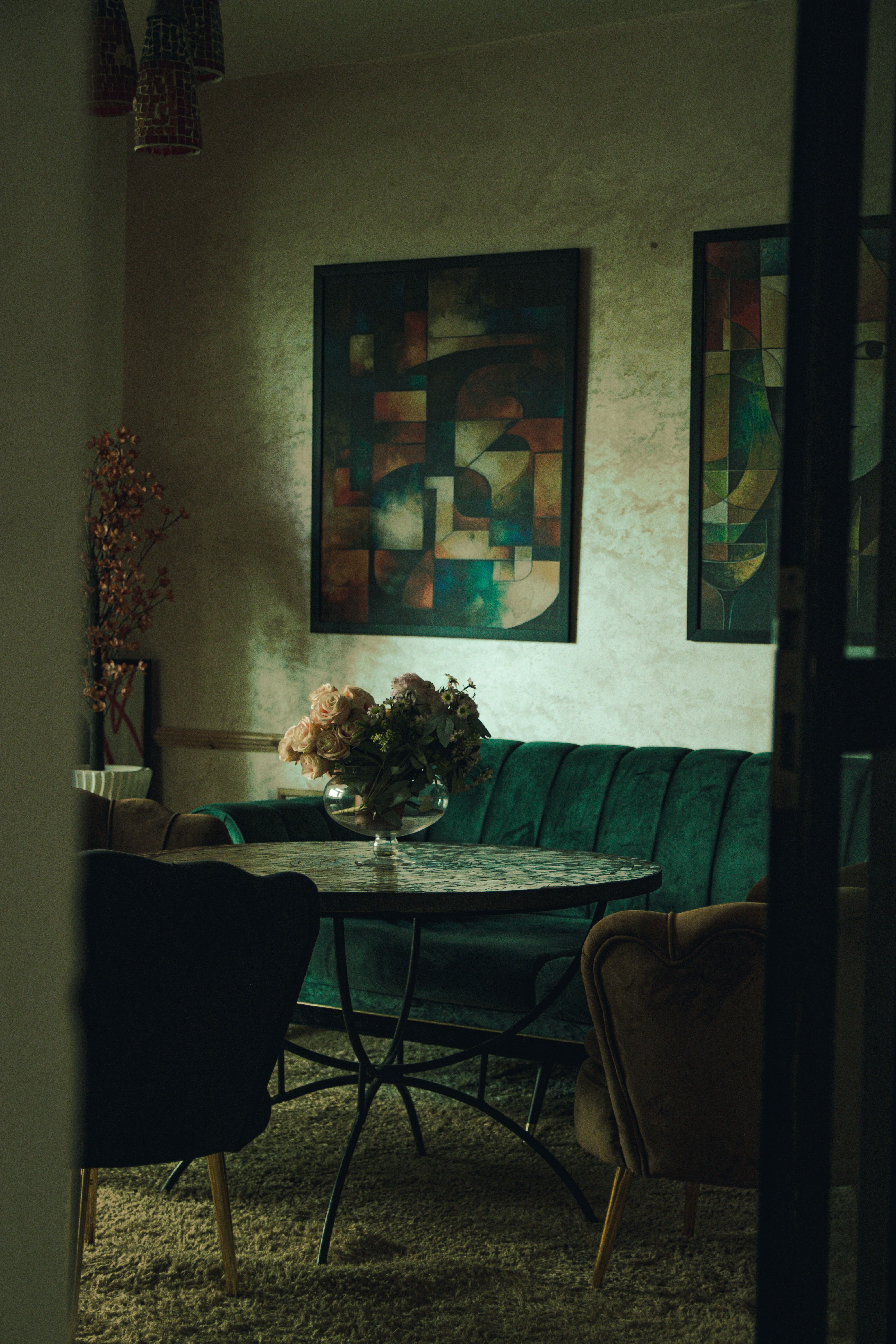 A warmly lit vintage-style cafe interior featuring abstract art and plush seating in Meknes, Morocco.