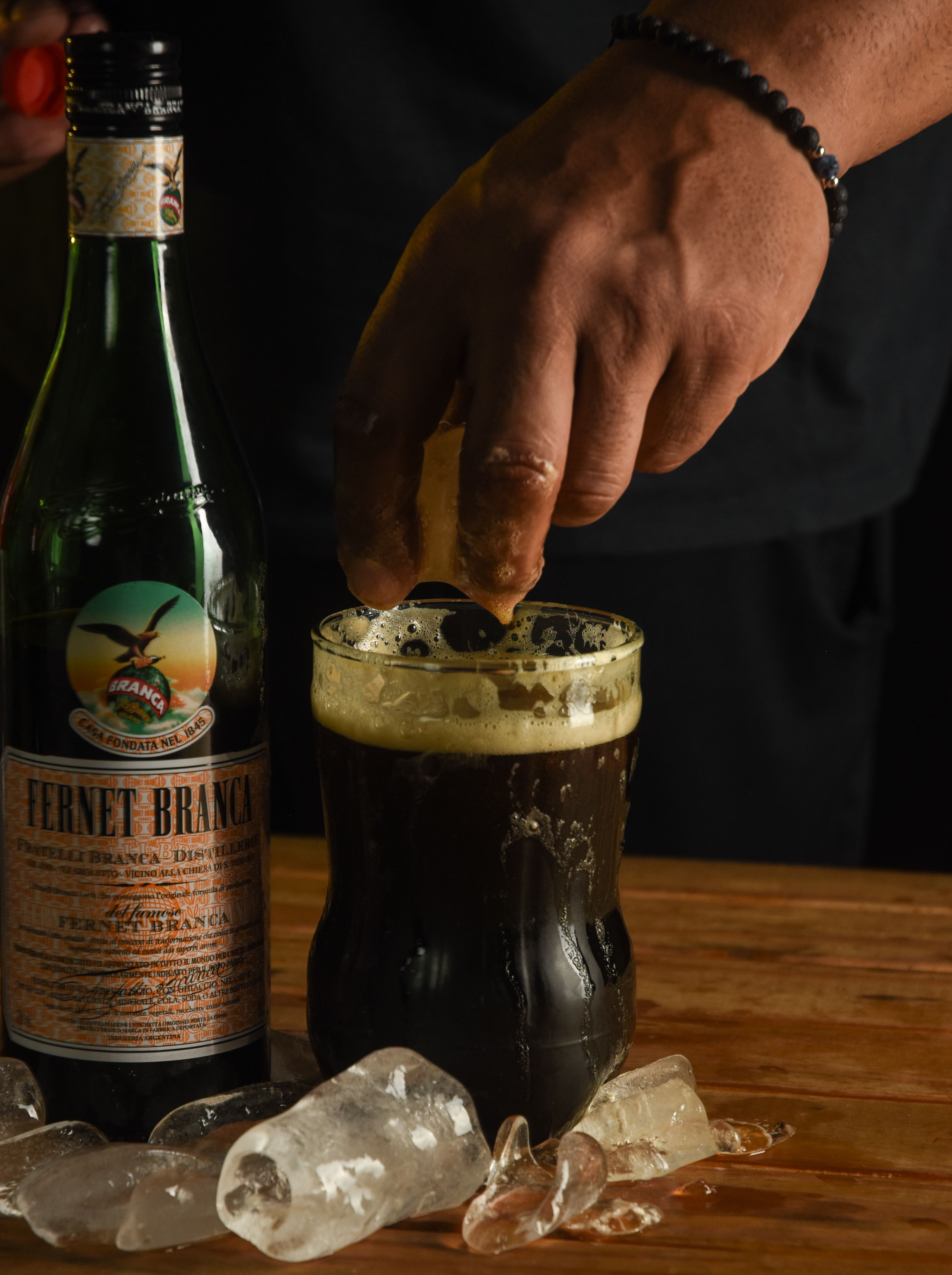 Fernet Branca with Ice and Citrus in Dark Ambience · Free Stock Photo