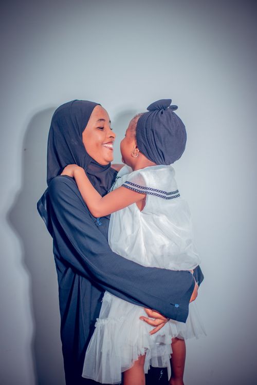 Free Beautiful moment of a mother and daughter sharing a joyful embrace indoors. Stock Photo