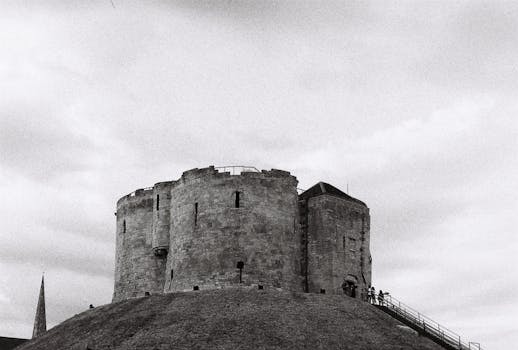 Black and white photo of Clifford's Tower in York, capturing its medieval architecture.