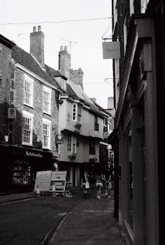 Black and white photo of a historic street in York, England with classic architecture.