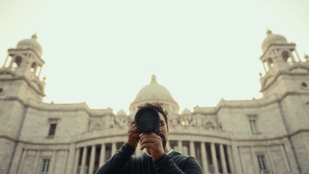 Photographer capturing an iconic historic landmark with grandeur architecture.
