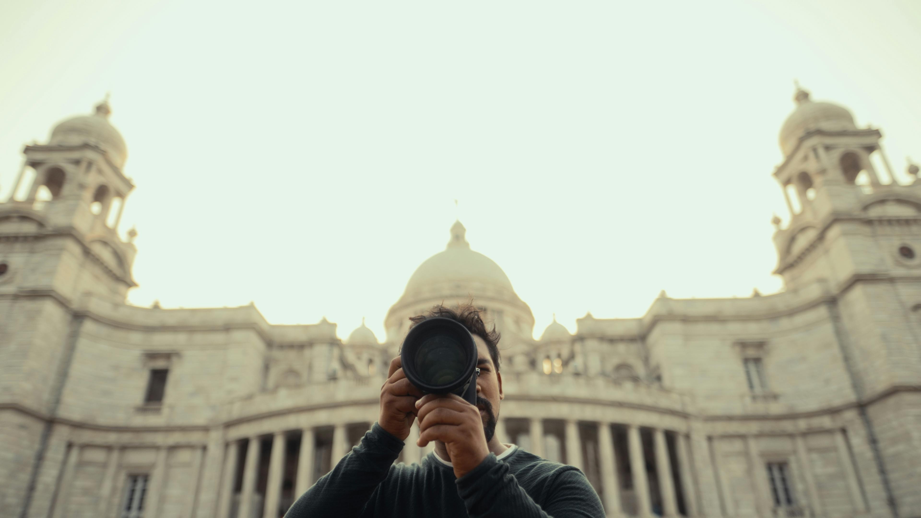 Free Photographer capturing an iconic historic landmark with grandeur architecture. Stock Photo