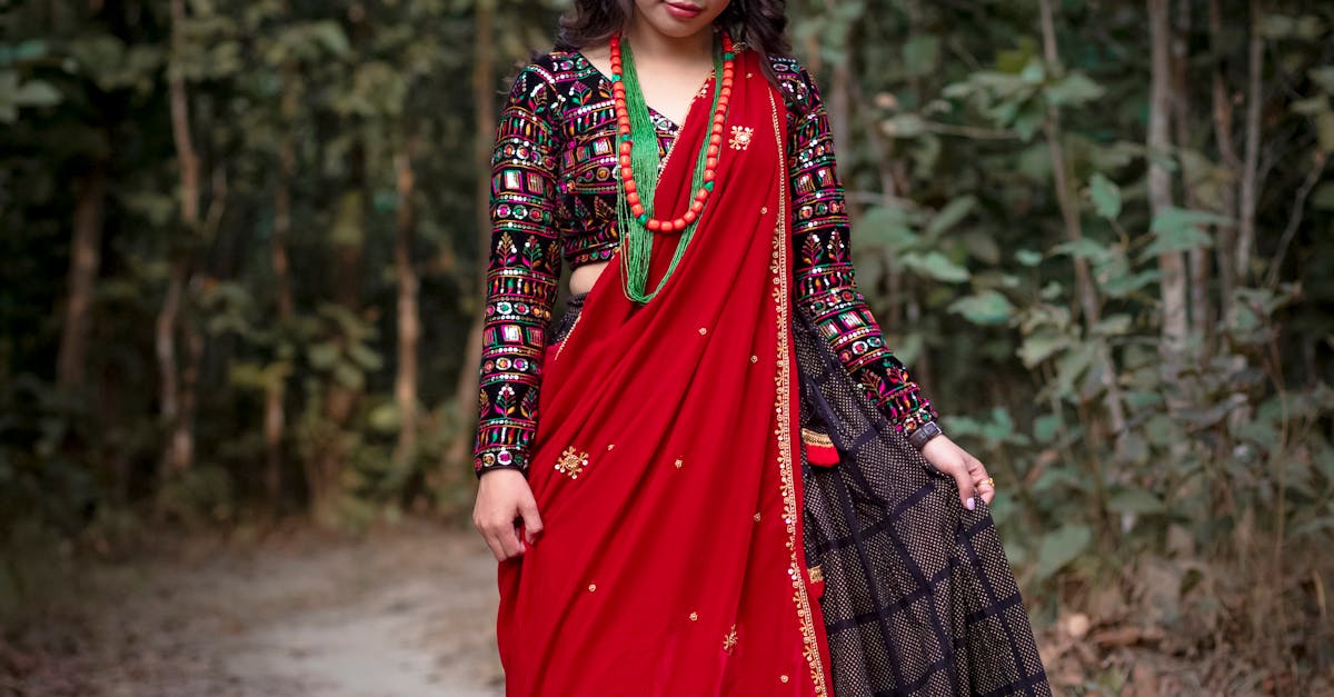 A young girl in traditional Nepali attire walks through a tranquil forest path.