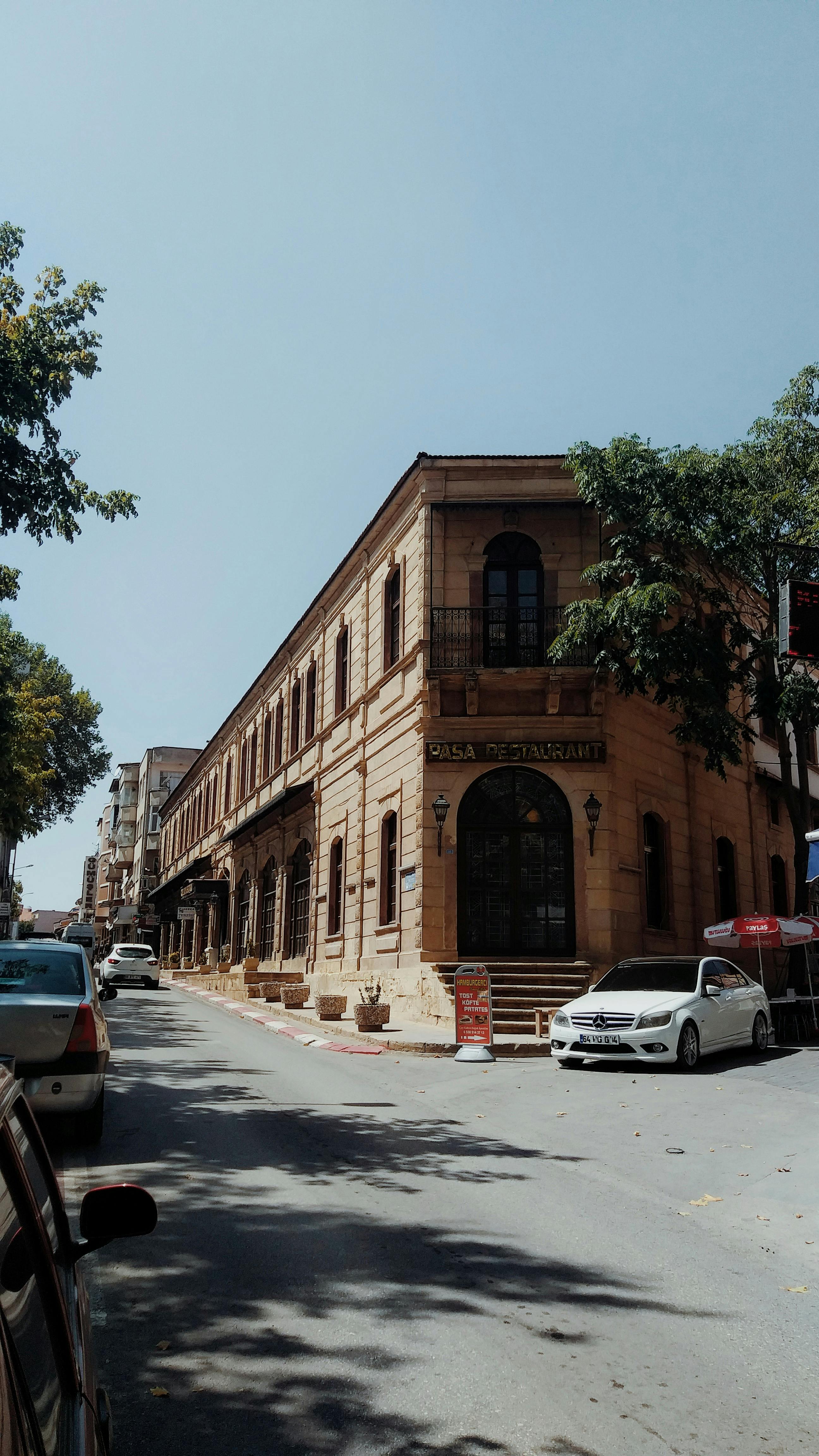 Street view of historic building in Uşak, Türkiye on a sunny day.