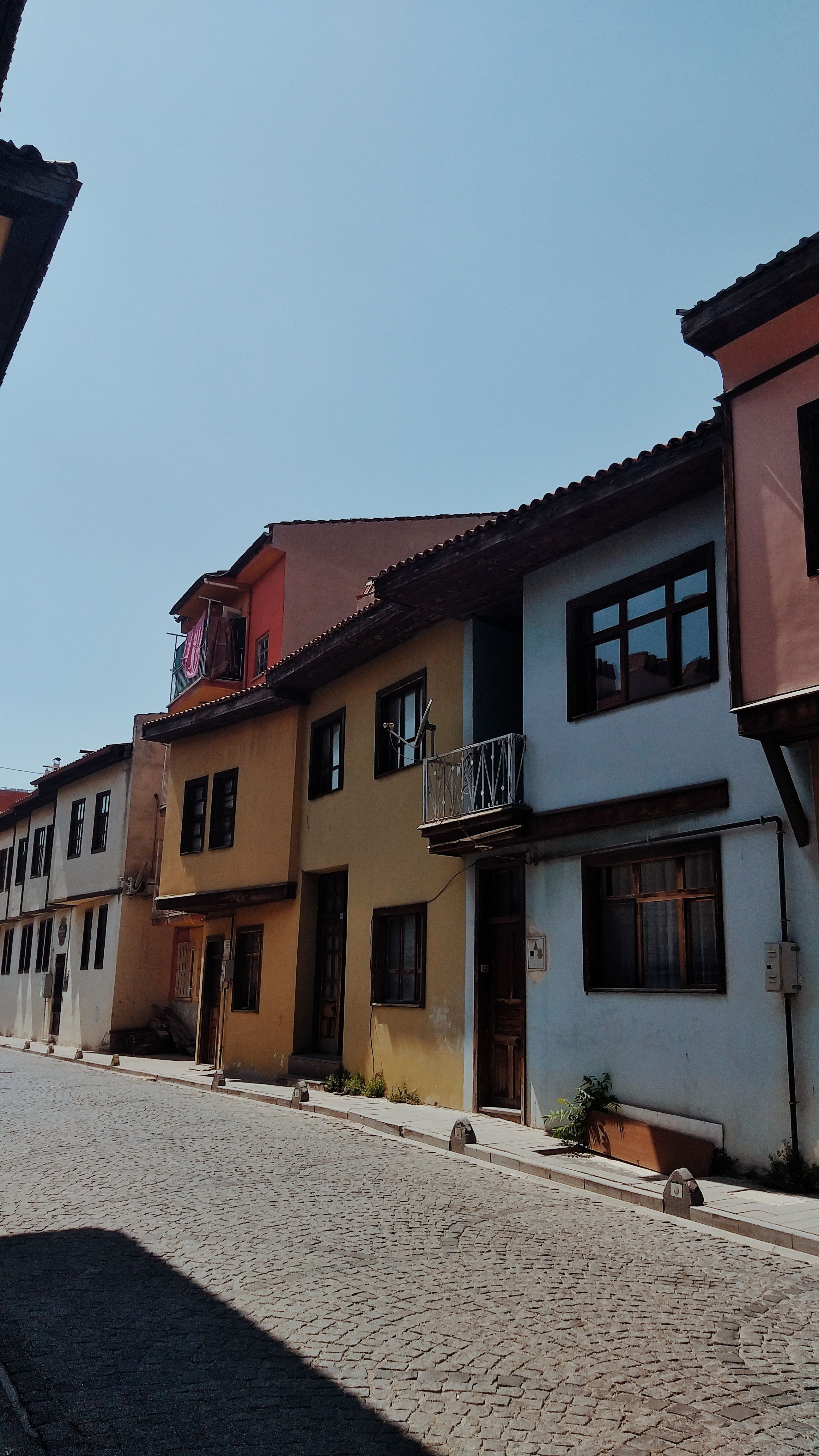 Beautiful colorful historic buildings on a sunny street in Uşak, Türkiye. Quiet and peaceful scene.