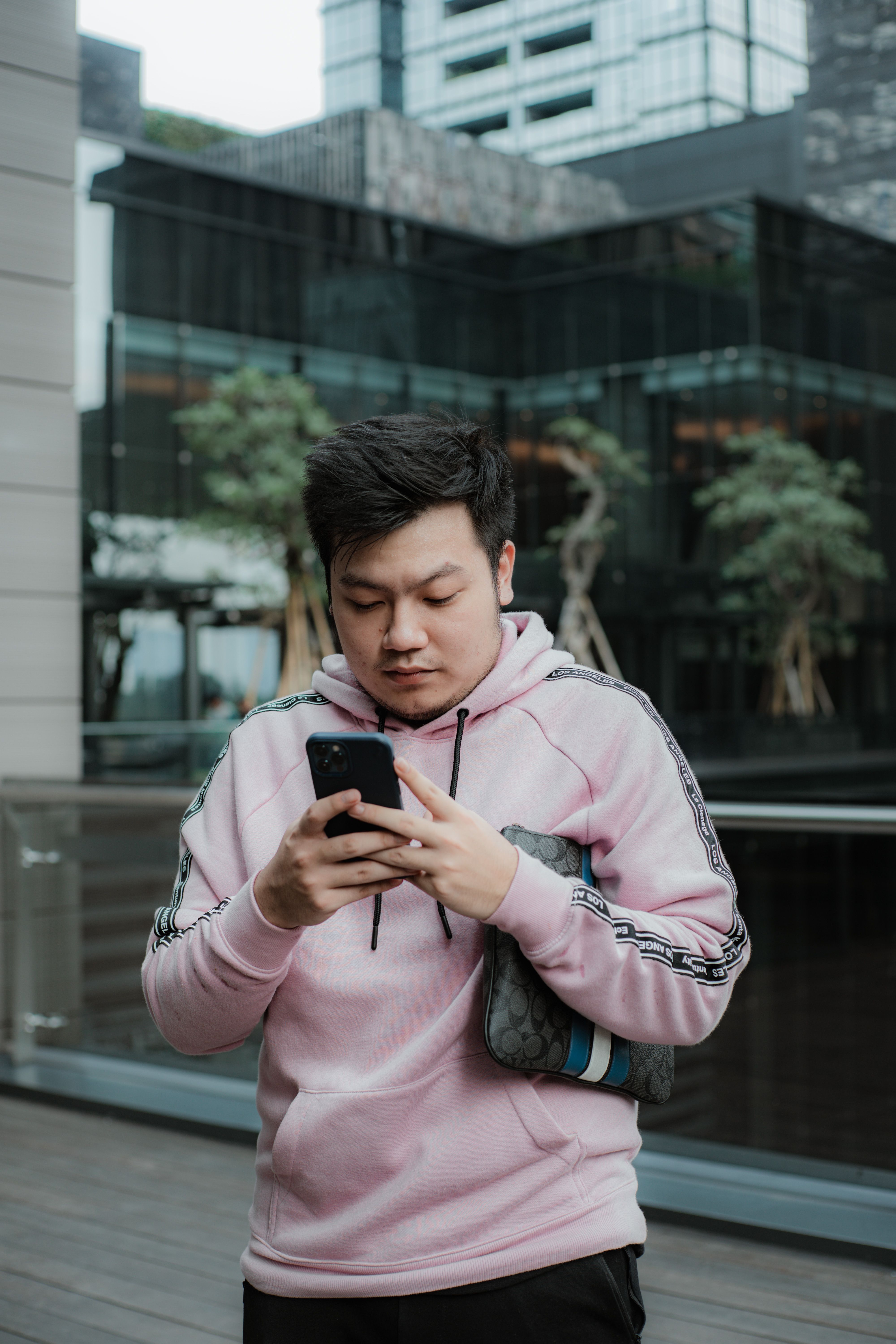 Young Man Using Smartphone in Urban Setting
