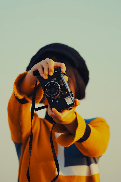 Person Holding Black Camera