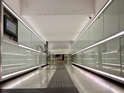 Free Spacious modern corridor with glass panels and bright lighting. Stock Photo