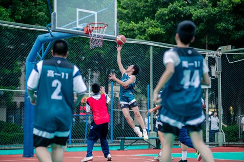 Free Energetic basketball game on an outdoor court featuring teenage players in action. Stock Photo