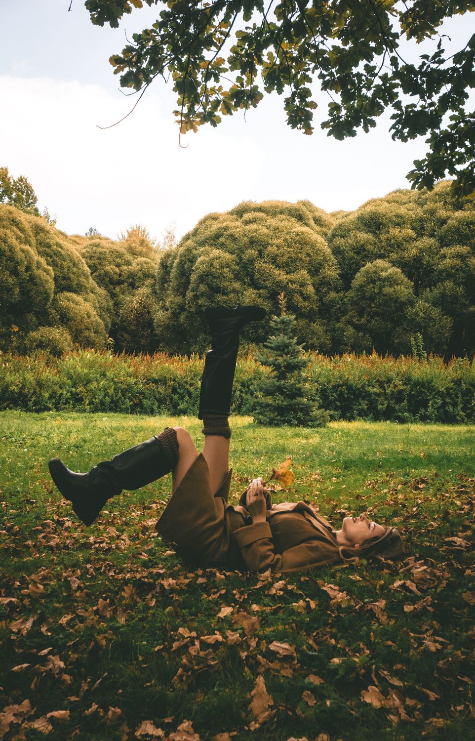 Woman Enjoying Autumn Leaves in a Park Setting · Free Stock Photo