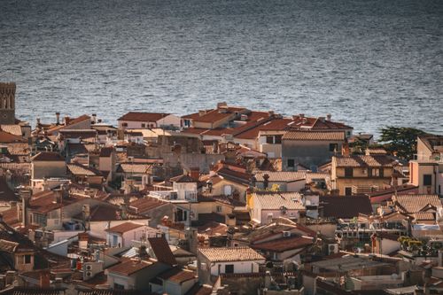 Free Aerial view of picturesque Mediterranean town rooftops by the sea. Stock Photo