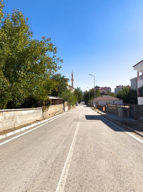 Free A tranquil street scene in Kovancılar, Elazığ with clear blue skies and residential buildings. Stock Photo
