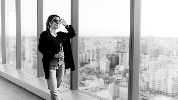 Woman enjoying a drink with a panoramic view of Buenos Aires skyline from a rooftop.