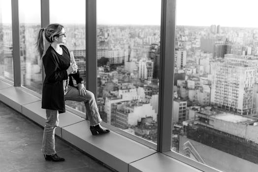 Black and white portrait of a woman on a Buenos Aires rooftop, enjoying the skyline view.