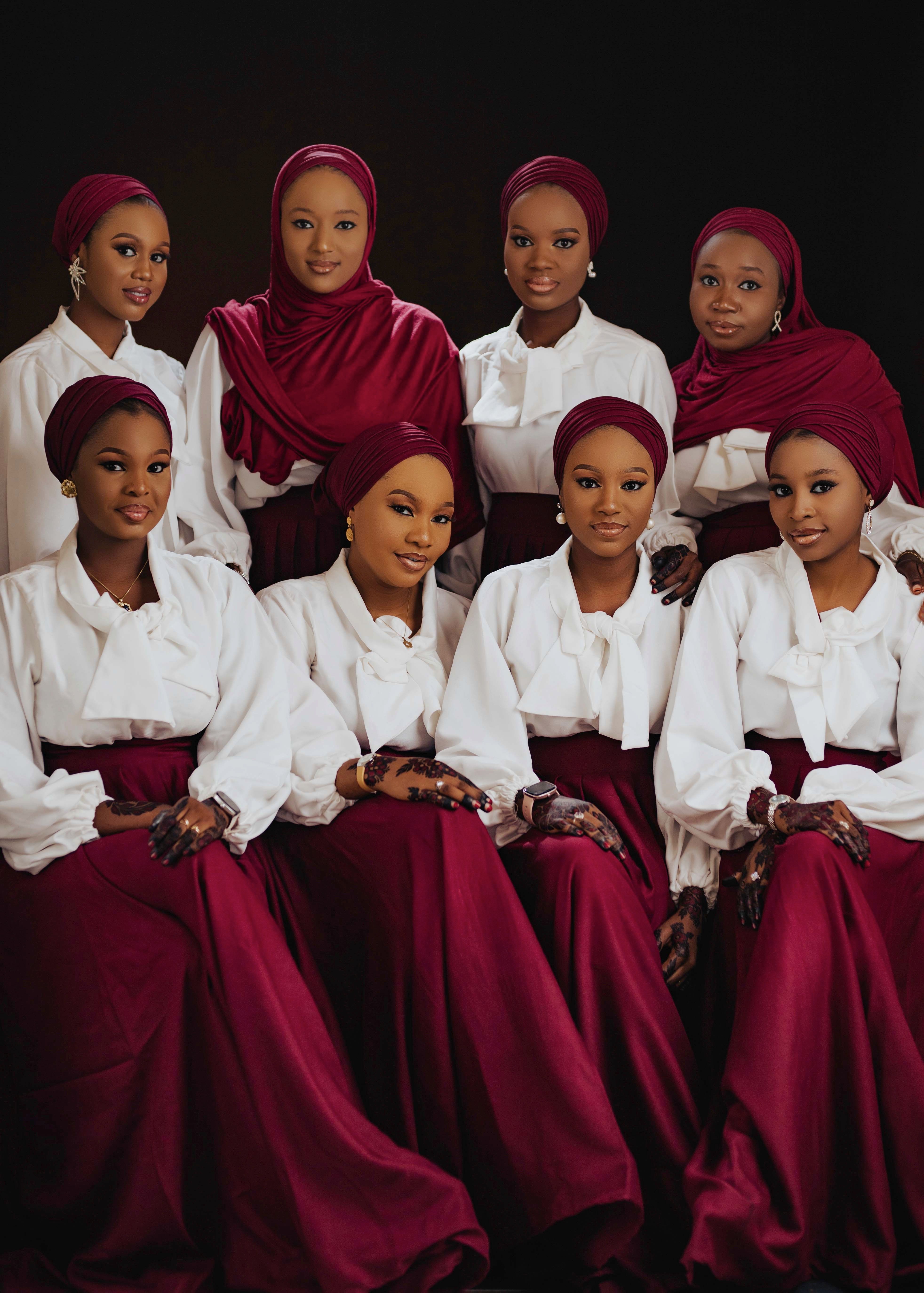 Elegant Group Portrait of Women in Red and White Attire · Free Stock Photo