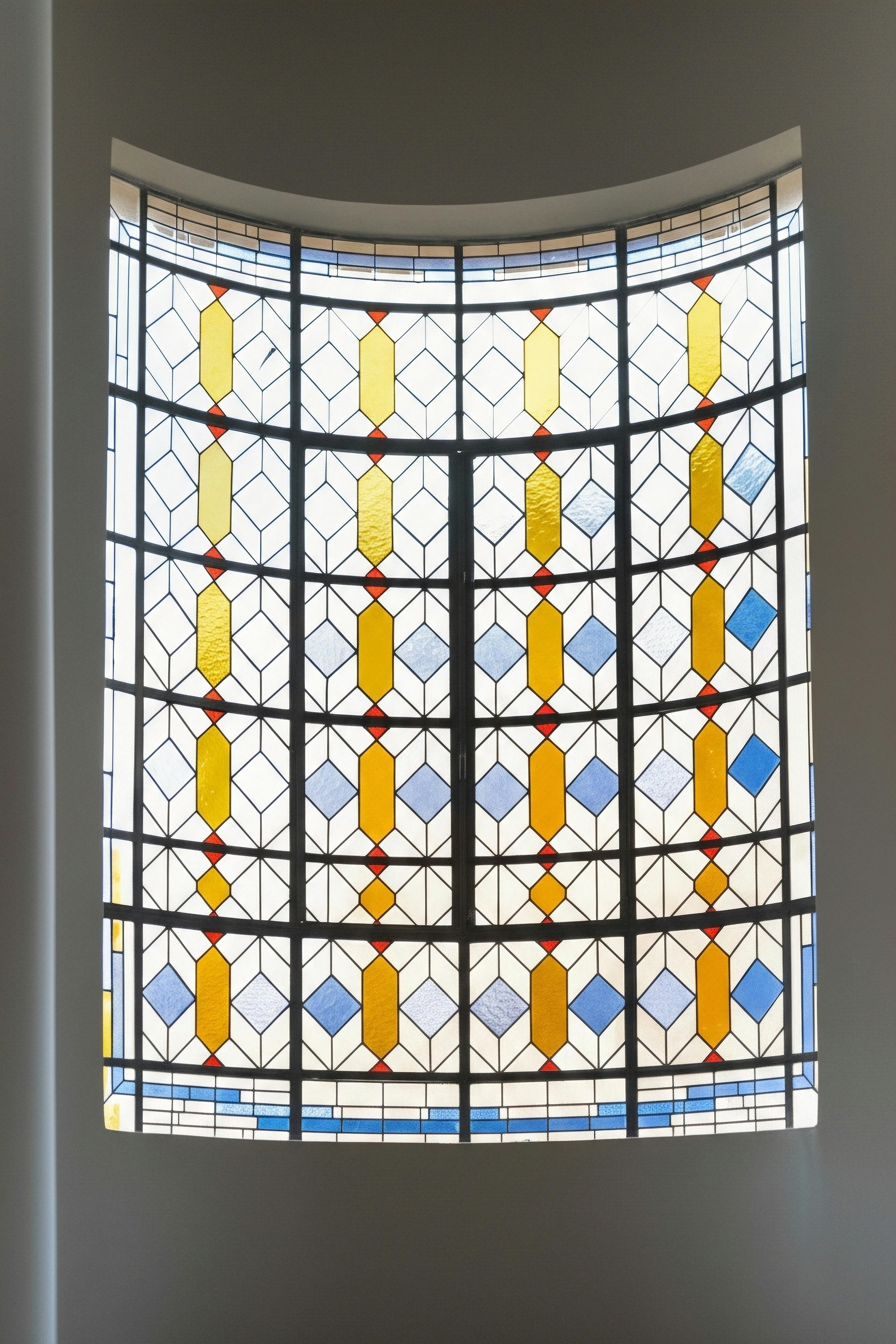 Colorful Geometric Stained Glass Window in Daylight · Free Stock Photo