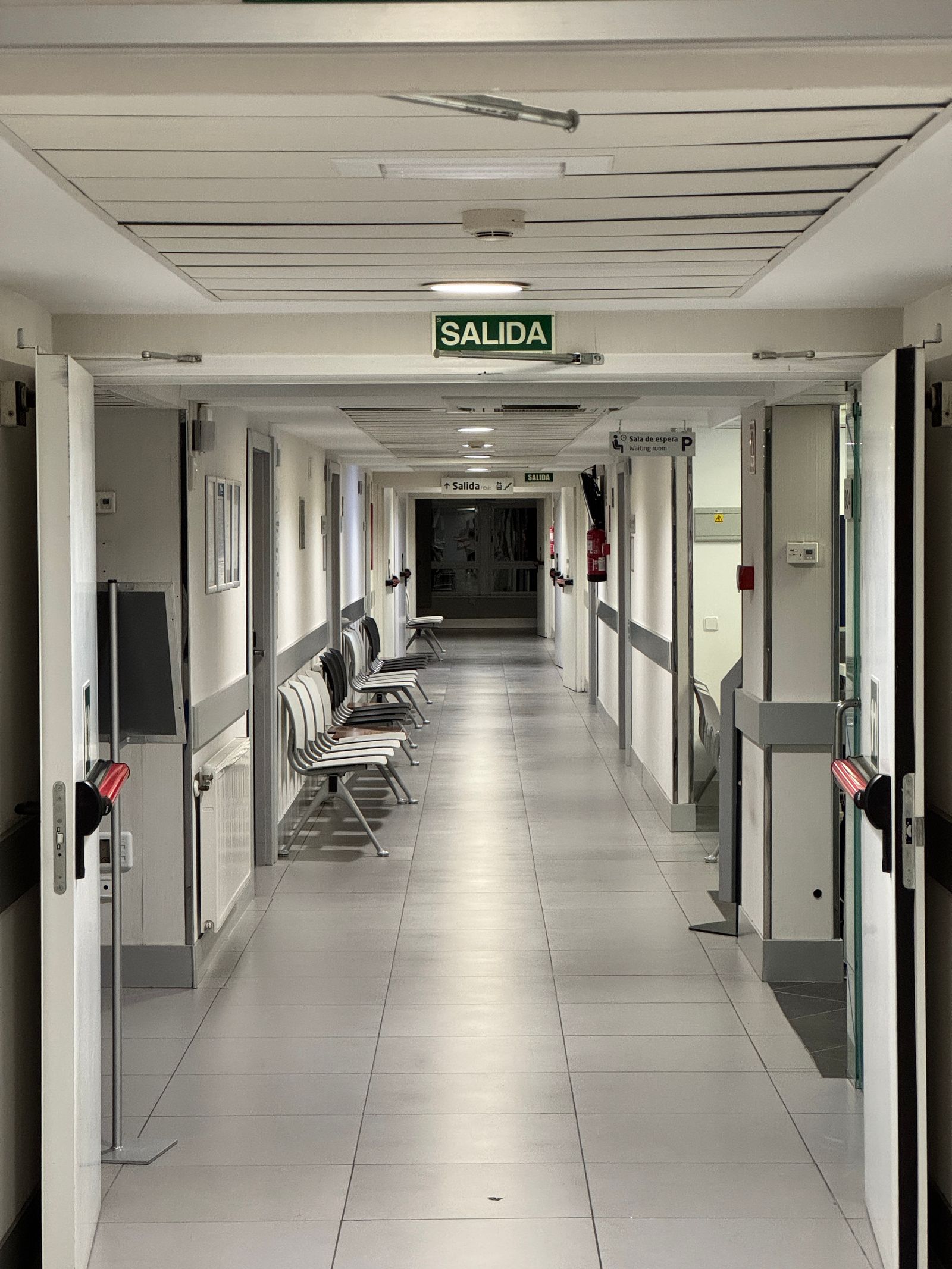 Long empty hospital corridor illustrating the travel path a bed must follow to reach the lift