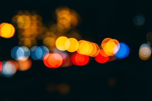 Free Colorful bokeh lights captured at night, creating an abstract and dreamy effect. Stock Photo