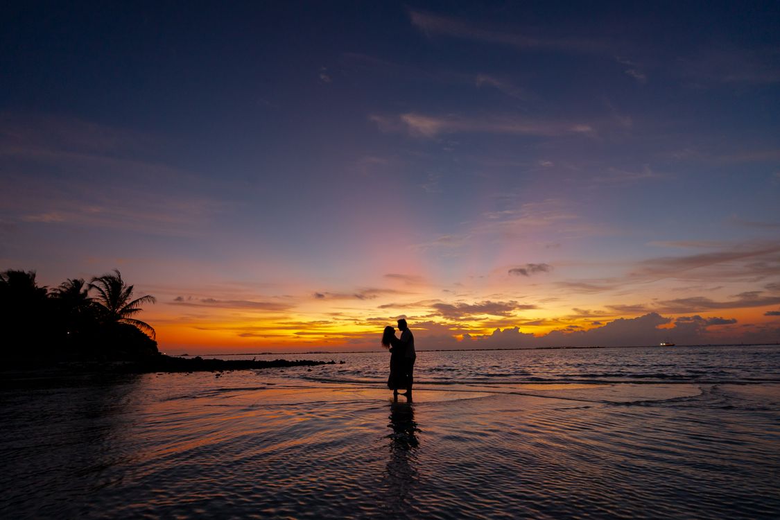 Romantic Couple Embracing at Sunset Beach · Free Stock Photo