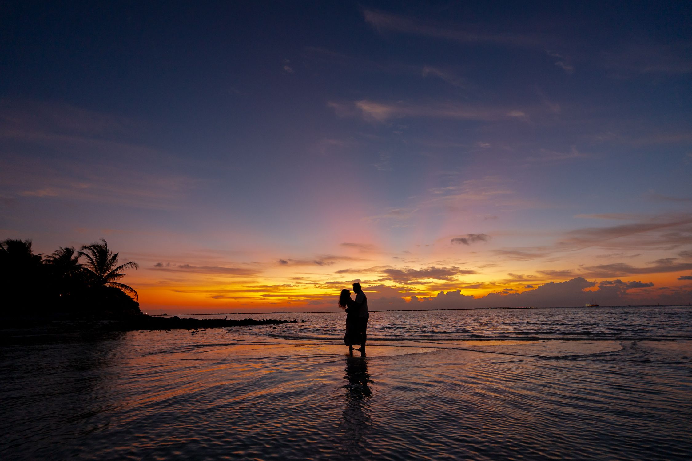 Romantic Couple Embracing at Sunset Beach · Free Stock Photo