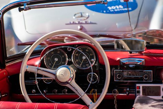Elegant vintage Mercedes-Benz interior showcasing a classic dashboard and steering wheel.