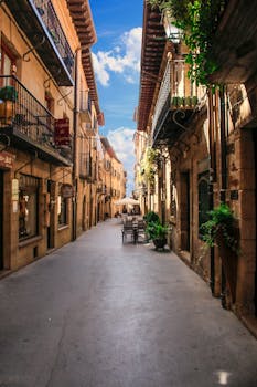 Historic street in Laguardia, Spain featuring quaint architecture and inviting outdoor cafes.