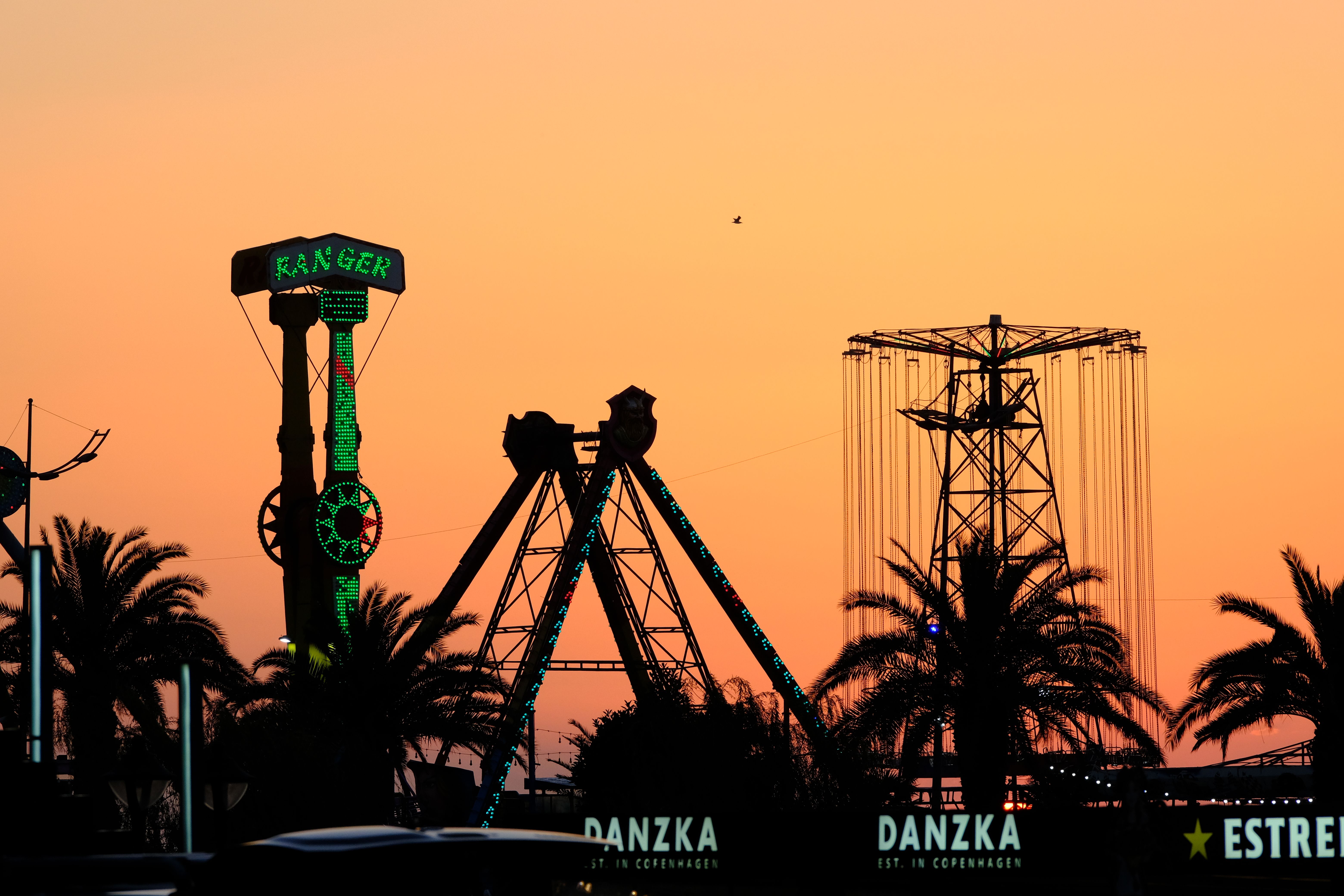Amusement Park Rides Silhouetted Against Sunset · Free Stock Photo