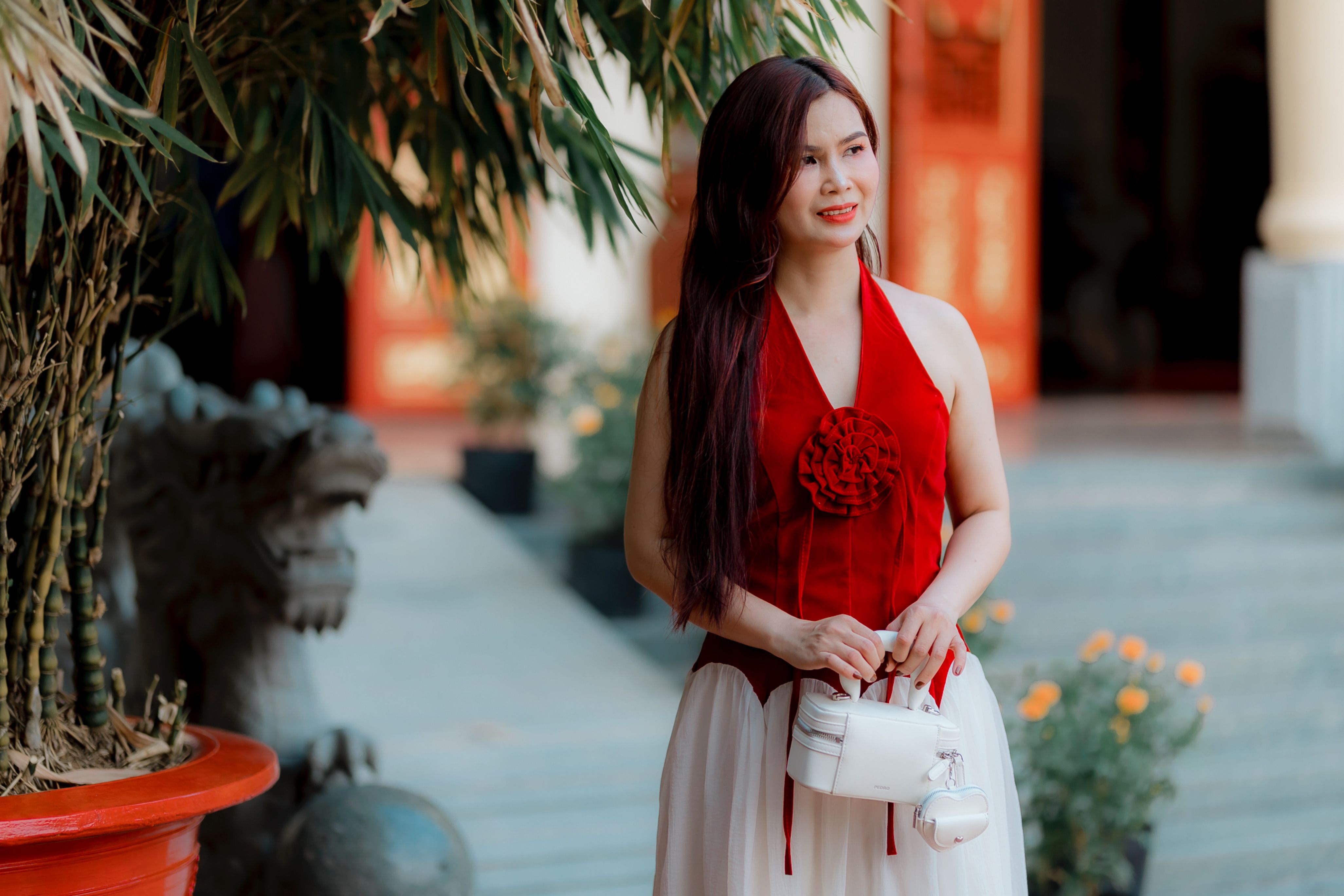 Elegant Woman in Red Dress at Traditional Setting · Free Stock Photo