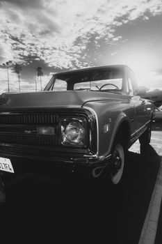 Stunning black and white image of a vintage truck at sunset, evoking nostalgia and timeless style.