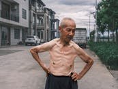 Elderly Man Relaxing Outdoors in Urban Setting