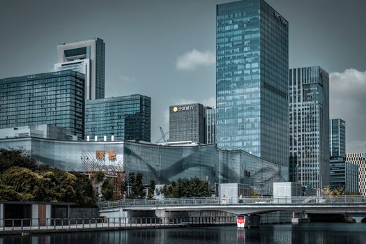 Skyscrapers stand tall against a clear sky, reflecting modern architecture in a bustling urban setting.