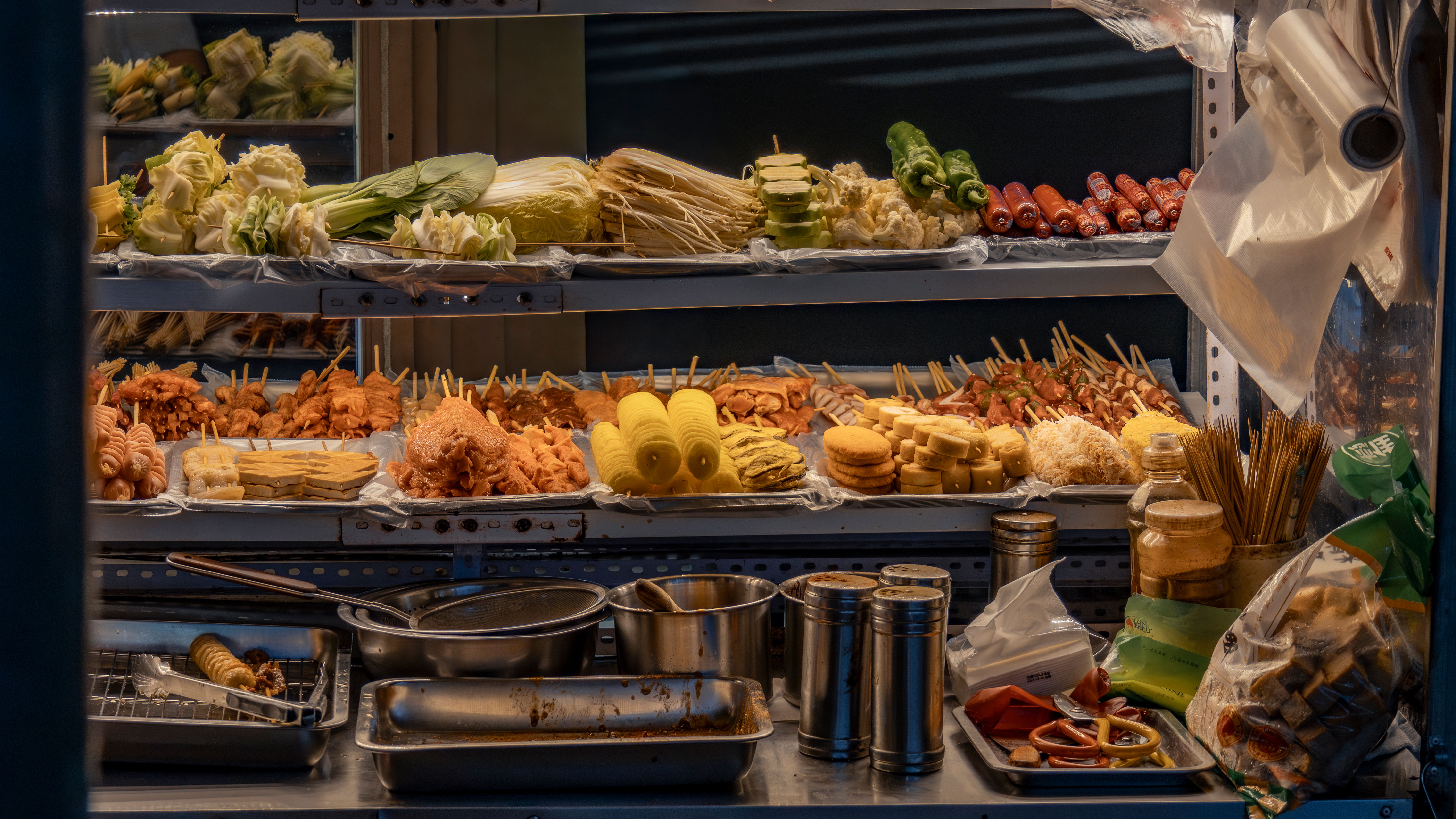 Street Food Stall Displaying Assorted Skewers · Free Stock Photo