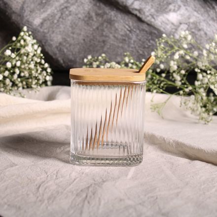 Ribbed glass storage jar with bamboo lid and spoon — photo by Fernanda Neitzel on Pexels