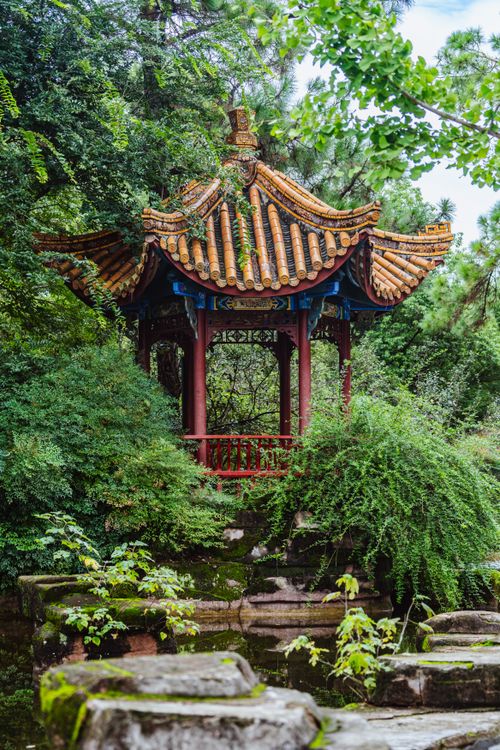 Free Beautiful traditional Chinese pavilion nestled in a vibrant, lush garden setting. Stock Photo