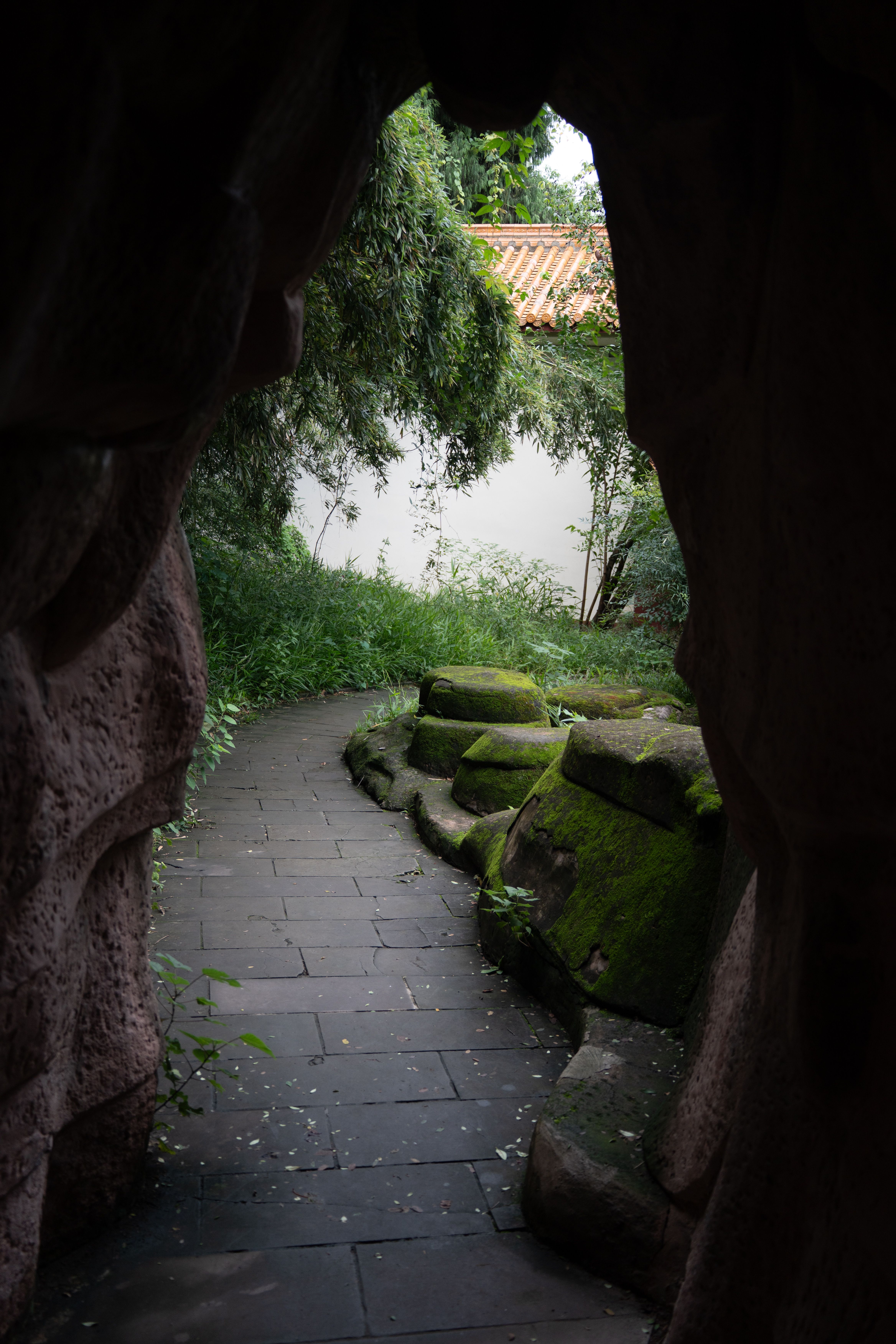 Tranquil Garden Pathway Through Stone Archway · Free Stock Photo