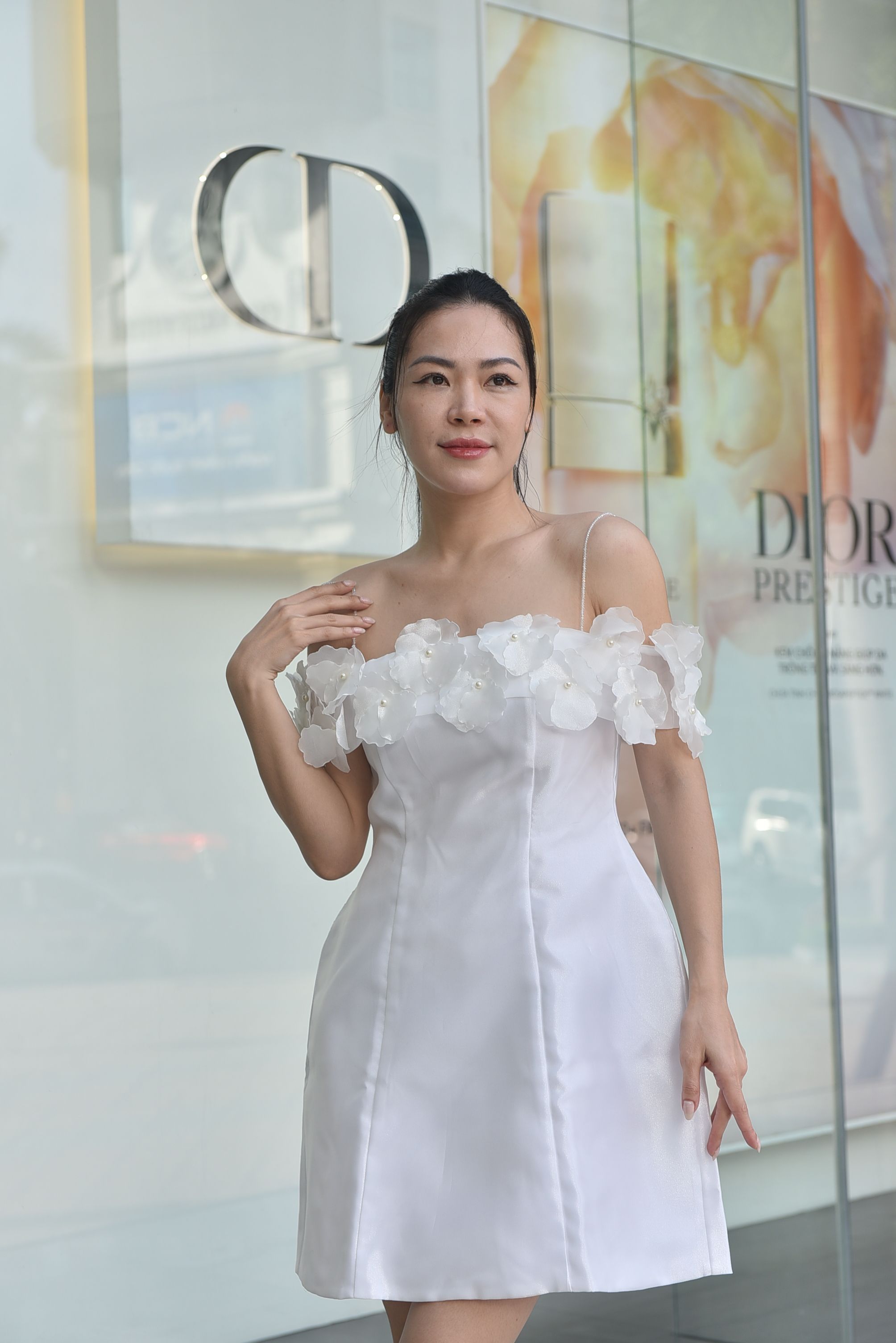 Elegant Woman in White Dress with Floral Details · Free Stock Photo