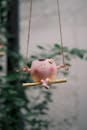 Charming Figurine on a Swing Outdoors