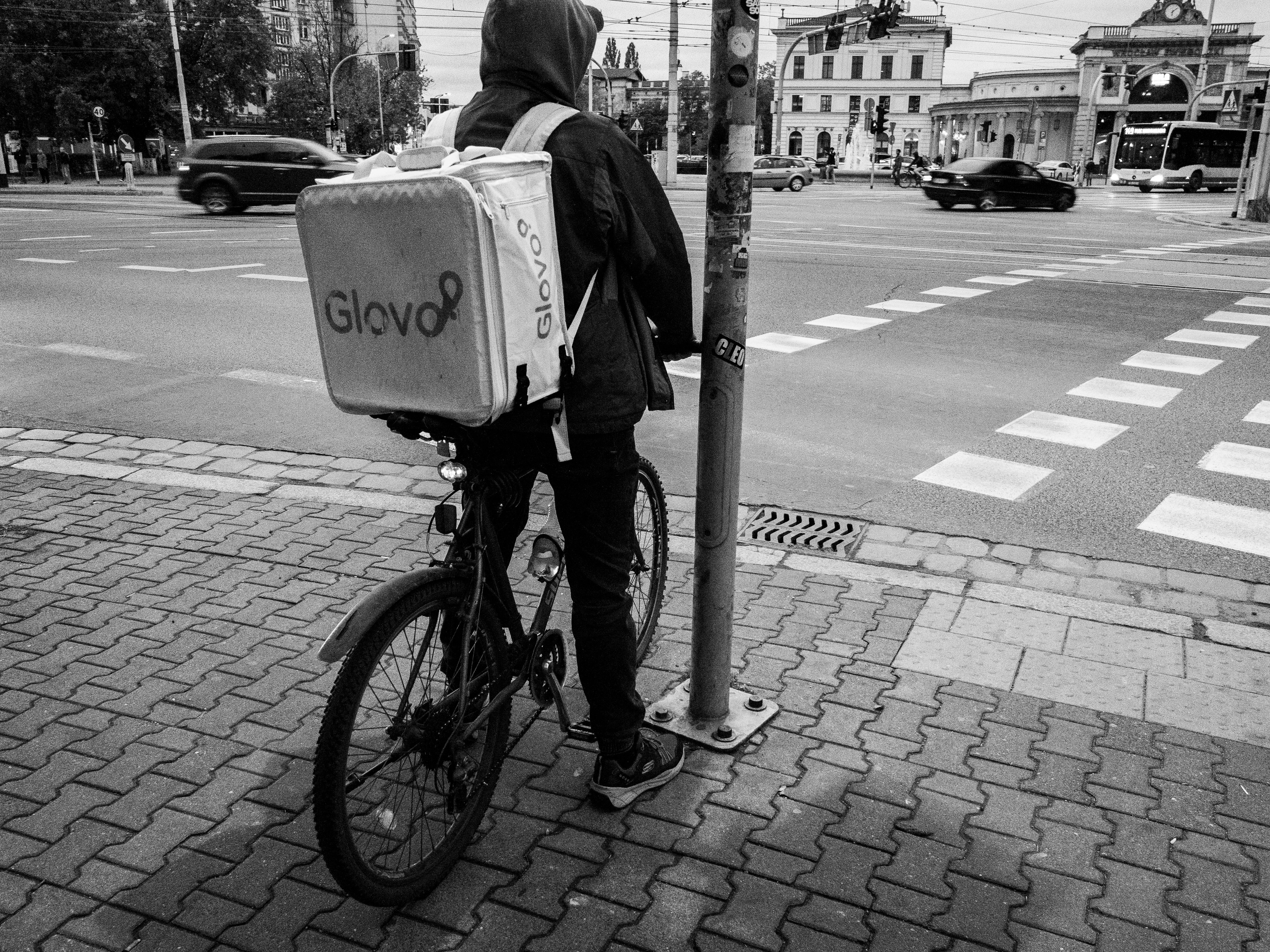 Urban Bicycle Delivery Rider Waiting at Crosswalk · Free Stock Photo