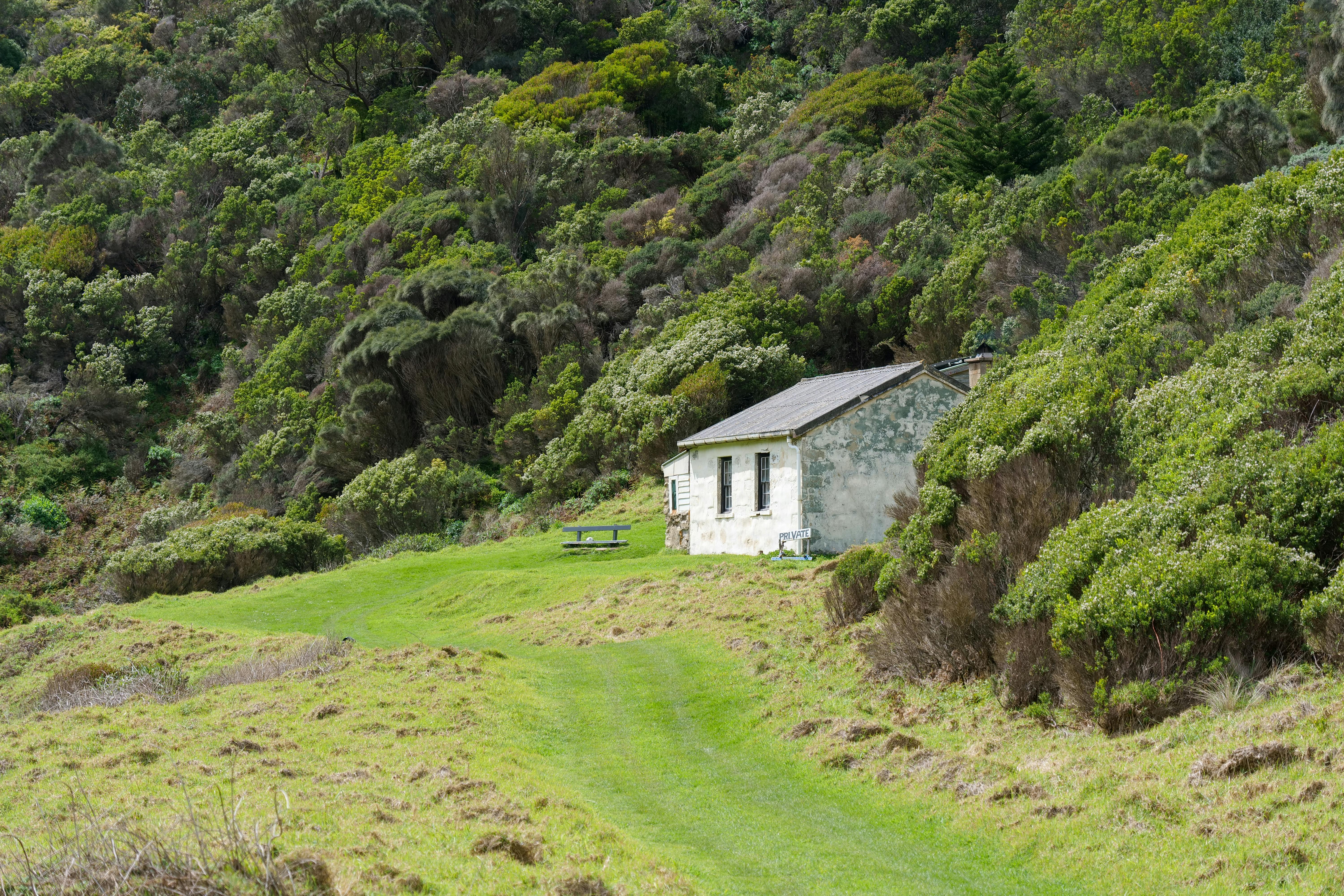 Scenic view of a rustic stone cottage surrounded by greenery in Victoria, Australia.