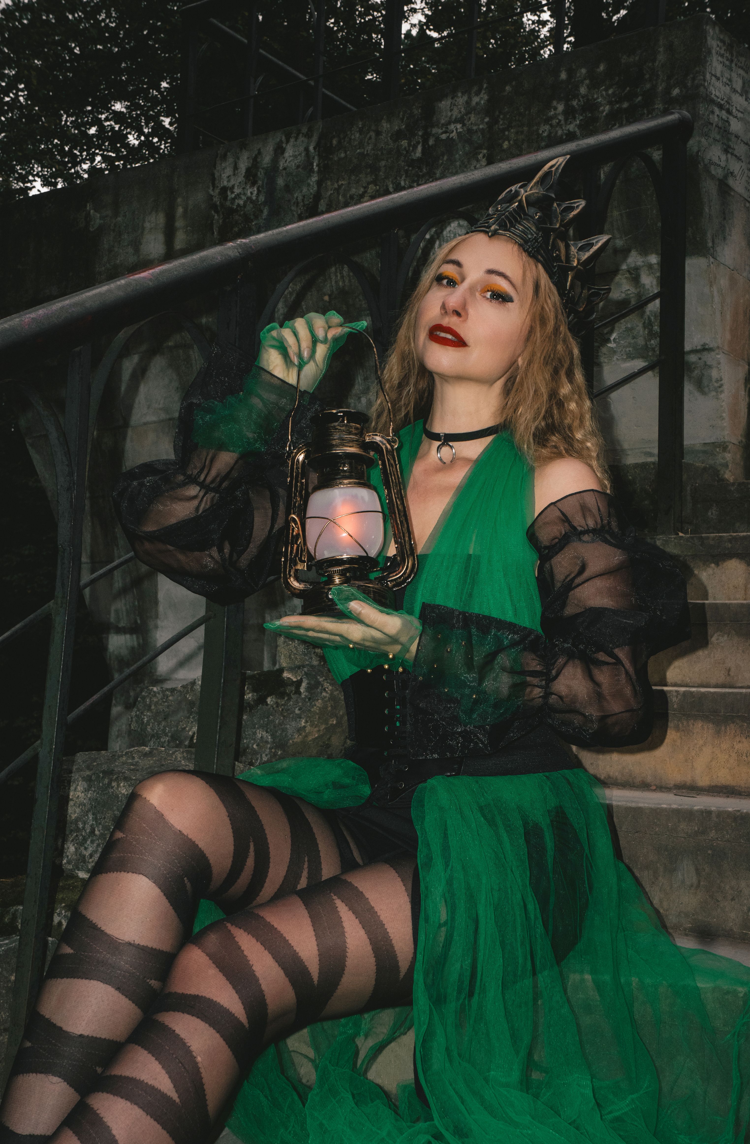 Mysterious Woman in Gothic Green Dress Holding Lantern  Free Stock Photo