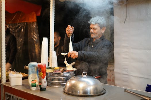 Turkish street vendor stretches traditional dondurma ice cream in a bustling night market.