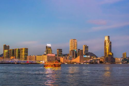 Free Dramatic view of Hong Kong's skyline and ferry on Victoria Harbour at sunset. Stock Photo