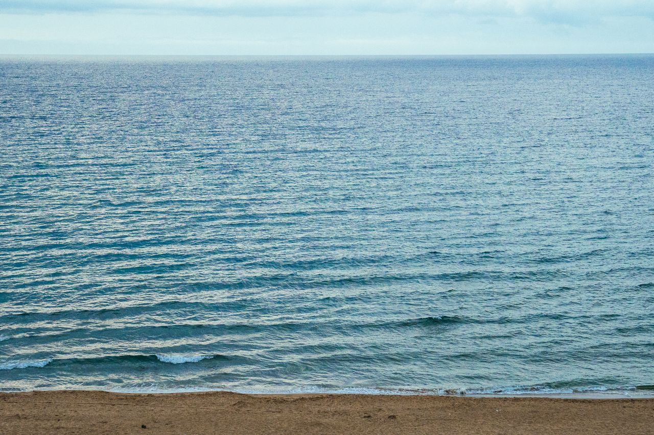 peaceful view of the ocean waves gently lapping the sandy shore under